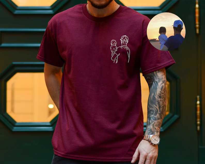 a man wearing a maroon shirt with a picture of a man on it