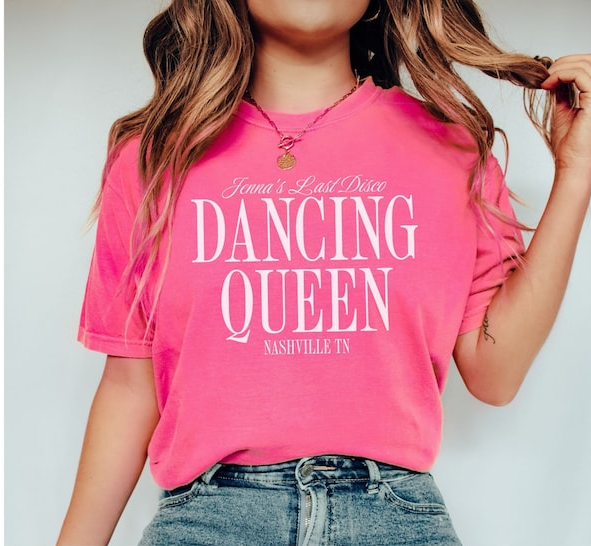 a woman wearing a pink shirt that says dancing queen
