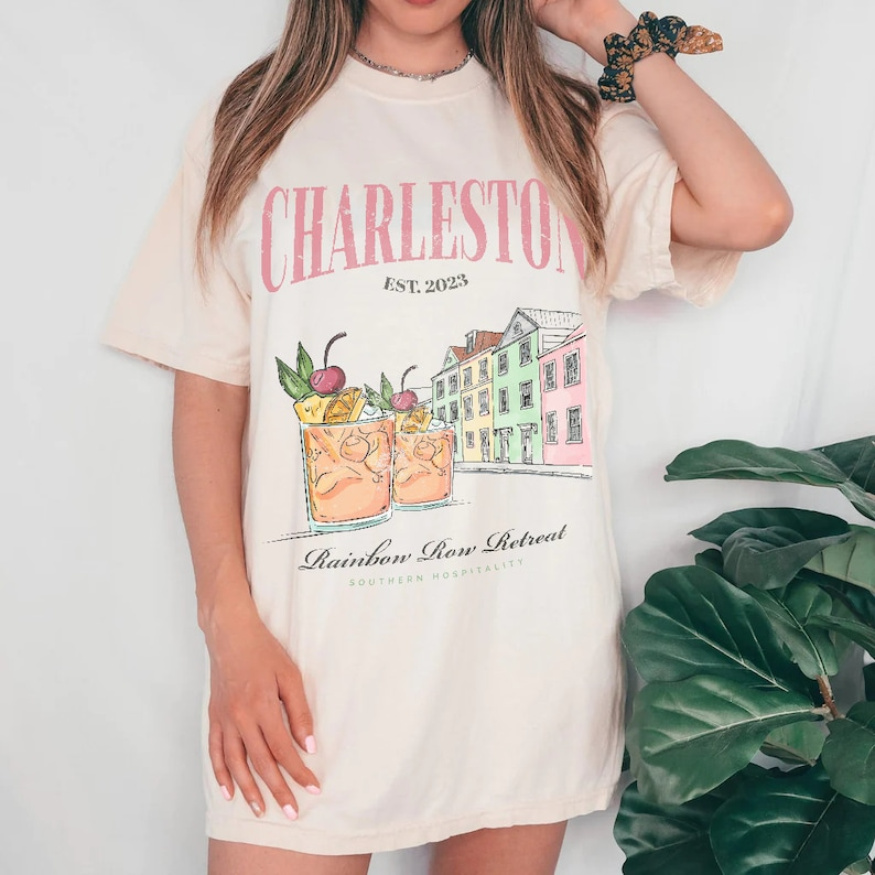 a woman wearing a charleston graphic t - shirt